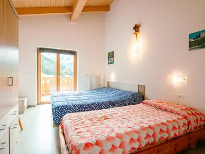 a bedroom with two beds and a window at Apartment Saslench by Interhome in Pera