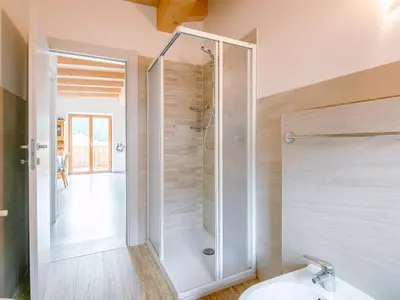 a hallway with white walls and a picture on the wall at Apartment Saslench by Interhome in Pera