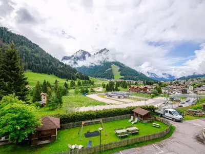 a view of a village with mountains in the background at Apartment Saslench by Interhome in Pera