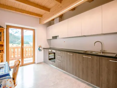 two beds in a room with a painting on the wall at Apartment Saslench by Interhome in Pera