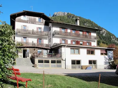 a large white building in front of a mountain at Apartment El Ladinia-1 by Interhome in Moena