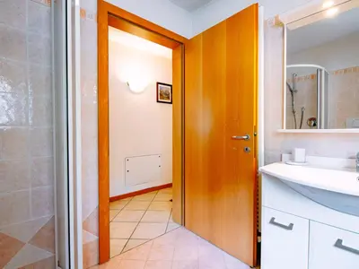 a bedroom with a bed and a table and a desk at Apartment Stabler by Interhome in Pera