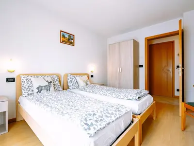 a bedroom with a bed and a wooden cabinet at Apartment Stabler by Interhome in Pera