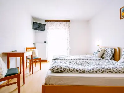 a kitchen with a living room with a red couch at Apartment Stabler by Interhome in Pera