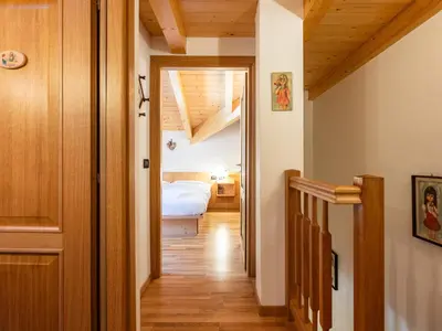 a hallway with a bedroom and a bed in a room at Apartment Cesa degli Abeti by Interhome in Campitello di Fassa