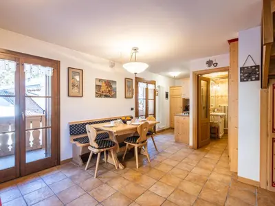 a kitchen and dining room with a table and chairs at Apartment Cesa degli Abeti by Interhome in Campitello di Fassa