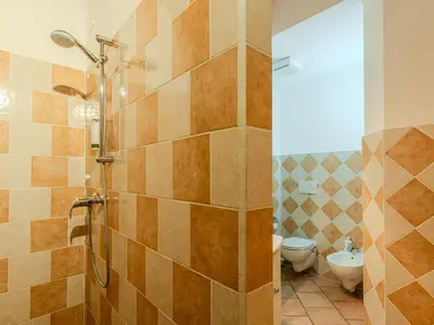 a room with a bed and a couch and a chair at Apartment Vento Alpino-2 by Interhome in Predaia