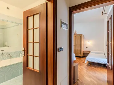 a bathroom with a sink and a mirror and a tub at Apartment Vento Alpino-3 by Interhome in Predaia