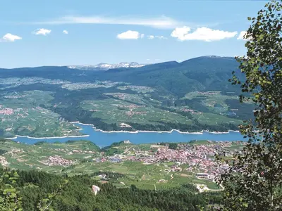 a view of a town and a lake in the mountains at Apartment Vento Alpino-3 by Interhome in Predaia