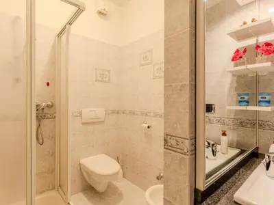 a bathroom with a sink and a tub and a mirror at Apartment Vento Alpino-3 by Interhome in Predaia