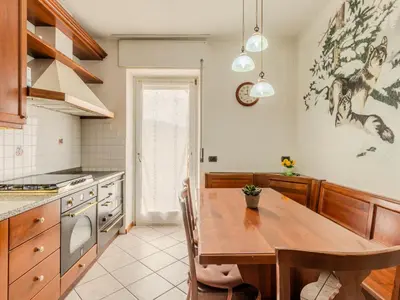 a bedroom with a bed and a desk and a window at Apartment Vento Alpino-3 by Interhome in Predaia
