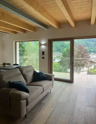 a living room with a couch and large windows at VILLA IRIS 6 persone in Transacqua