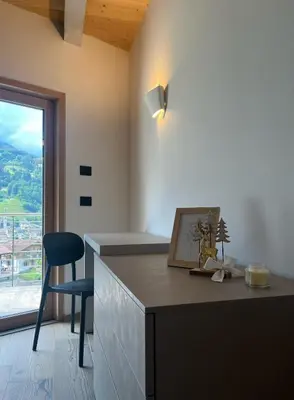 a kitchen with a desk with a chair and a window at VILLA IRIS 6 persone in Transacqua