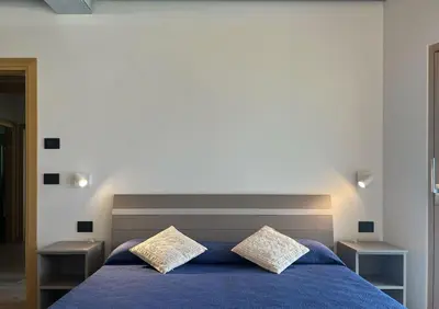 a bedroom with a blue bed with two night stands at VILLA IRIS 6 persone in Transacqua