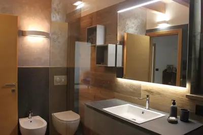 a bathroom with a sink and a toilet and a mirror at VILLA IRIS 6 persone in Transacqua
