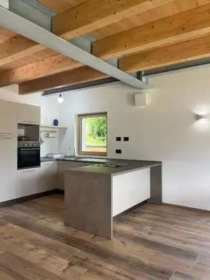 a kitchen with white walls and a wooden ceiling at VILLA IRIS 6 persone in Transacqua