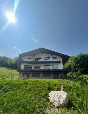 a building on a hill with a rock in front of it at VILLA IRIS 6 persone in Transacqua