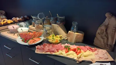a table with two plates of food on a counter at Guesthouse Dolomiten in Egna