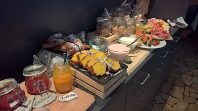 a buffet with various types of food on a table at Guesthouse Dolomiten in Egna
