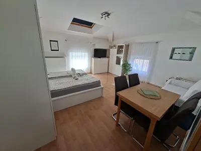 a living room with a bed and a dining room table at Apartment Anna in Merano