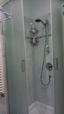 a shower with a glass door in a bathroom at Apartment Anna in Merano