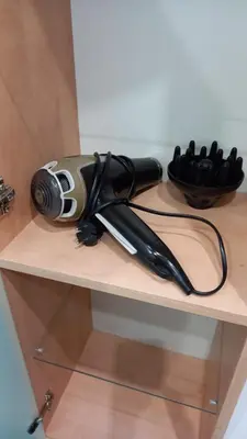 a hair dryer sitting on top of a shelf at Apartment Anna in Merano