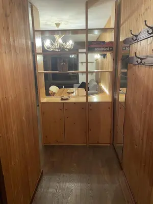 a room with wooden cabinets and a mirror in a room at CIASA LAURINA - Apartment near the slopes with Dolomite views in Carezza al Lago
