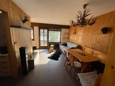 a living room with a table and a couch at CIASA LAURINA - Apartment near the slopes with Dolomite views in Carezza al Lago
