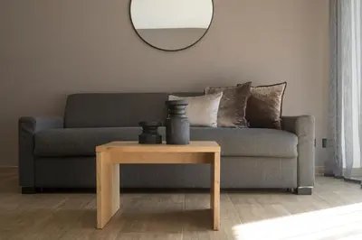 a living room with a couch and a table with a mirror at Residence Sonja in Rablà