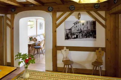 a living room with two chairs and a table at Hotel Bellaria - Cortina d'Ampezzo in Cortina dʼAmpezzo