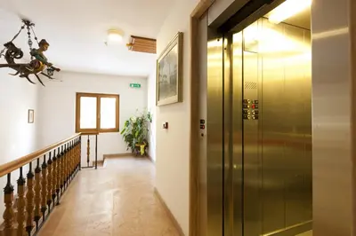a hallway with a glass door and stairs at Hotel Bellaria - Cortina d'Ampezzo in Cortina dʼAmpezzo