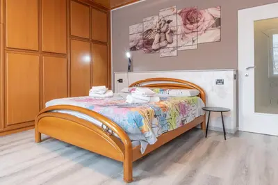 a bedroom with a bed and a table in it at All'Uno, Taio Ospitar in Taio