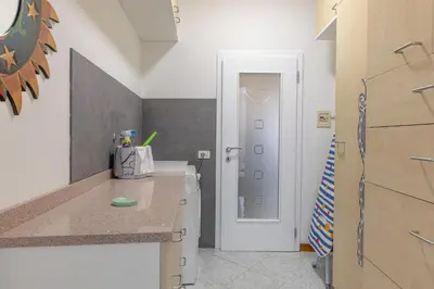 a small kitchen with a counter and a refrigerator at All'Uno, Taio Ospitar in Taio