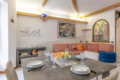 a living room with a table and a couch at All'Uno, Taio Ospitar in Taio