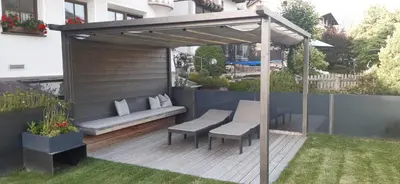 a gazebo with two chairs and a bench on a deck at Apartment Manuel in Ortisei