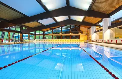 a large swimming pool with a large ceiling at Apartment Manuel in Ortisei