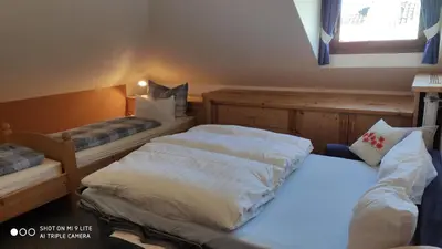 a bedroom with two beds and a window at Apartment Manuel in Ortisei