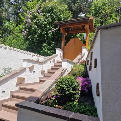 a set of stairs in a garden with flowers at Appartamento Genzianella Monolocale in Cavalese
