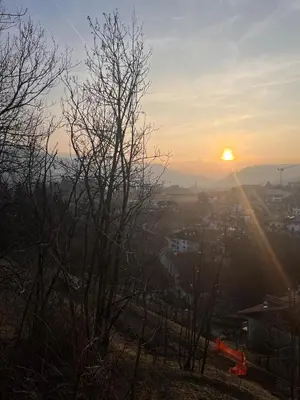 a view of the sun setting over a city at Appartamento Genzianella Monolocale in Cavalese