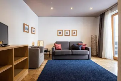 a living room with a couch and a tv at Waldelerhof- Appartements in Meransen in Maranza