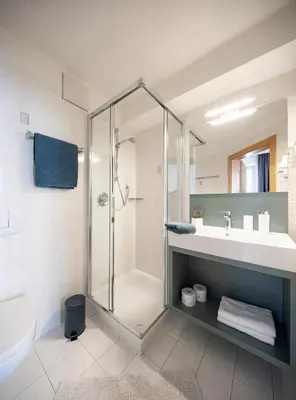 a bathroom with a shower and a sink at Waldelerhof- Appartements in Meransen in Maranza