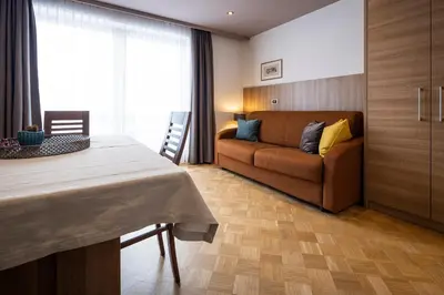a living room with a couch and a table at Waldelerhof- Appartements in Meransen in Maranza