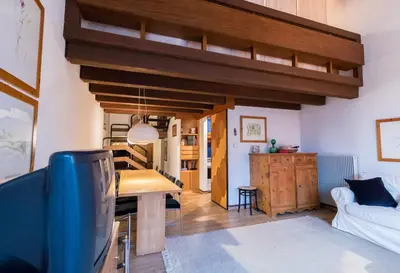 a living room with a couch and a dining room at Residence SOLARIA in Campestrin