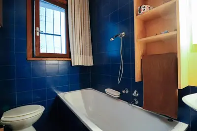 a bathroom with a tub and a toilet and a window at Residence SOLARIA in Campestrin