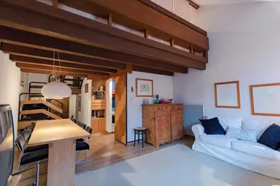 a living room with a white couch and a loft at Residence SOLARIA in Campestrin