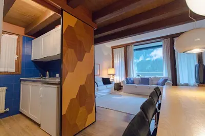 a kitchen and living room with a table and chairs at Residence SOLARIA in Campestrin