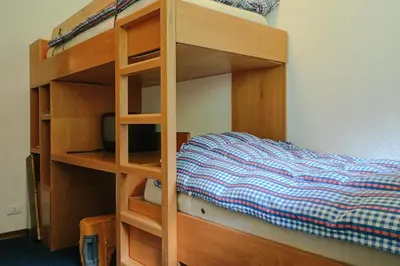 a wooden bunk bed in a room with a bed at Residence SOLARIA in Campestrin