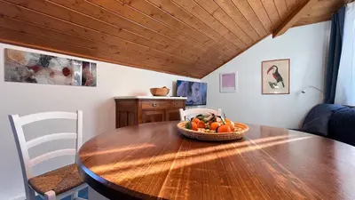 a small kitchen and dining room with a table and chairs at mardolomiti suite in Appiano sulla Strada del Vino
