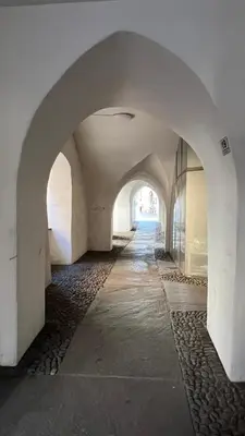 an empty hallway with an archway in a building at mardolomiti suite in Appiano sulla Strada del Vino