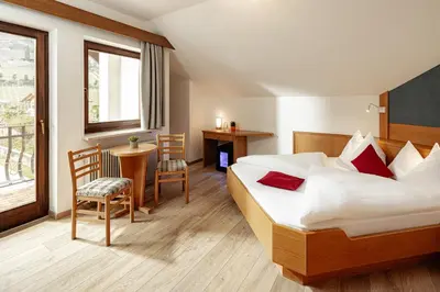 a hotel room with a bed and a window at Kalterer See Hof in Caldaro